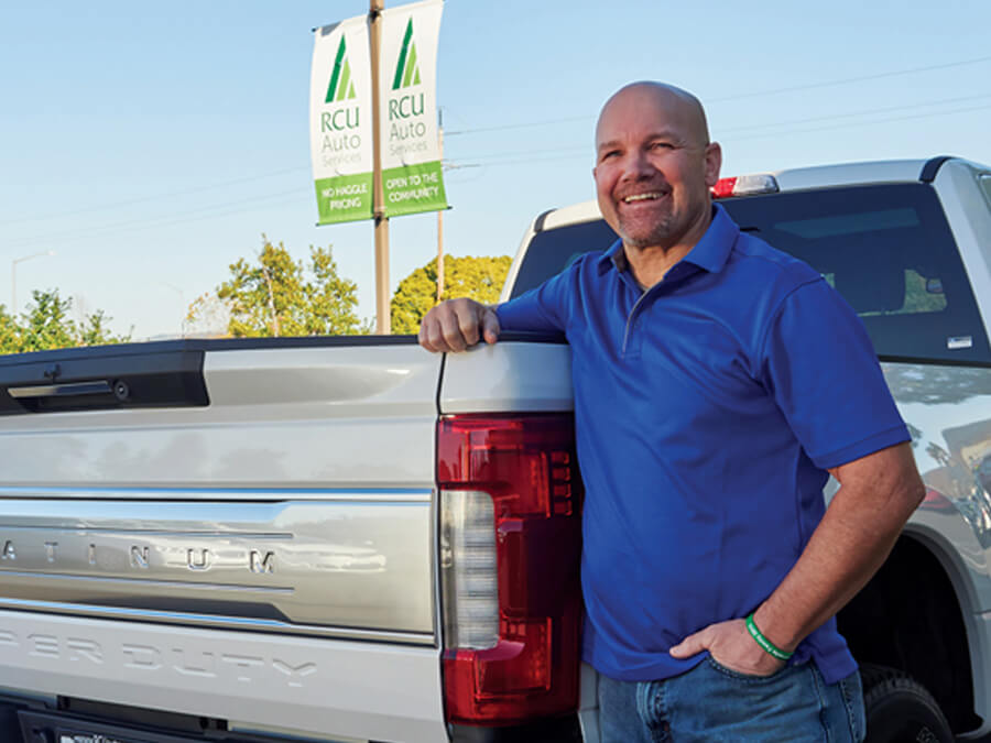 Happy customer standing near car door smiling