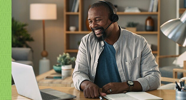 Man on computer with headset