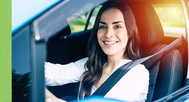 Young couple high-fiving at each other in the car