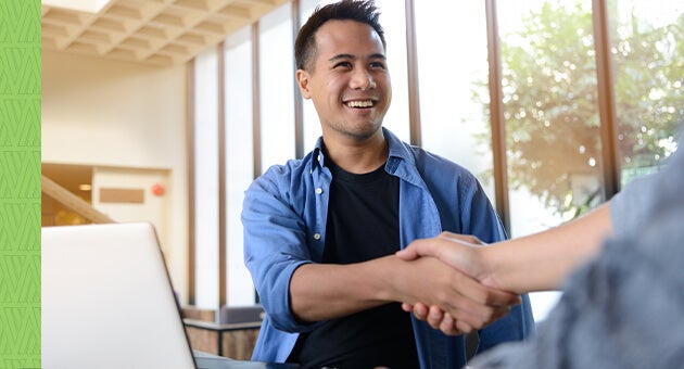 Young man shaking hands with an RCUAS rep.