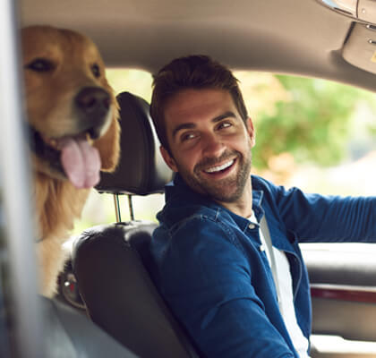 Man in car with dog